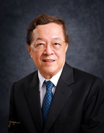 A gentleman in a navy suit and tie, corporate portrait