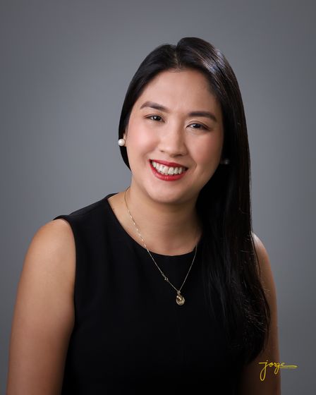 A smiling woman in a black sleeveless top